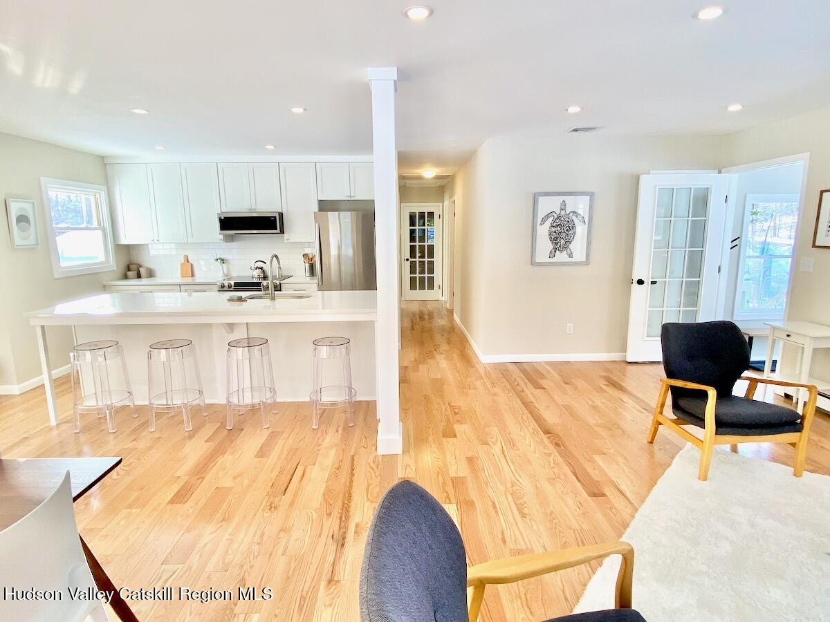 132 Weeds Mill Road Highland, NY 12528 - Photo 9 of 37 a living room with stainless steel appliances kitchen island granite countertop furniture and a flat screen tv