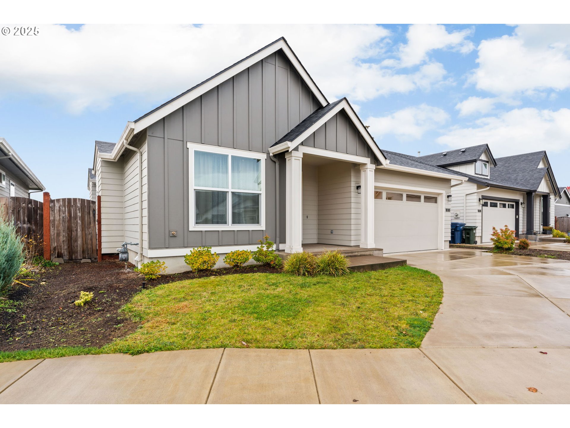 1030 53rd Place Springfield, OR 97478 - Photo 3 of 39 a view of a white house with a yard patio and a small yard