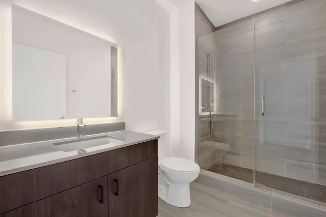 a bathroom with a sink toilet and shower