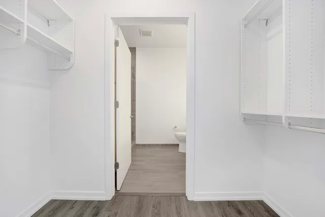 a view of a room with wooden floor