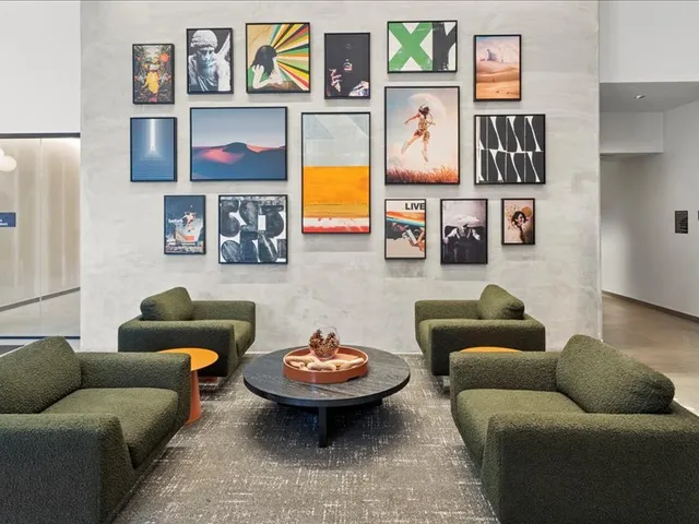 a living room with furniture and painting on the wall