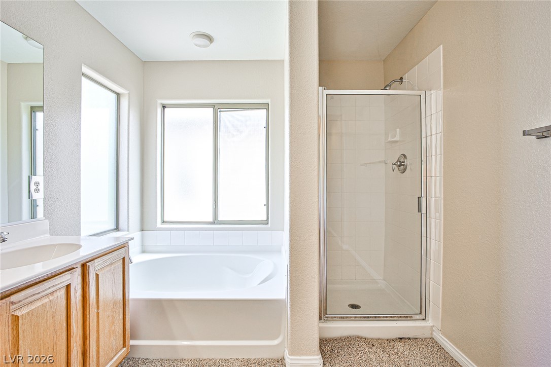 8022 Diamond Gorge Road Las Vegas, NV 89178 - Photo 31 of 37 A spacious layout features a separate glass shower enclosure and a built-in soaking tub.