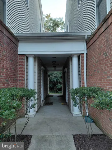 a view of a brick house with potted plants