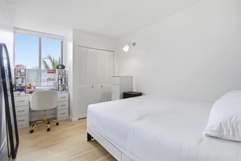 a bedroom with a bed and a table in it