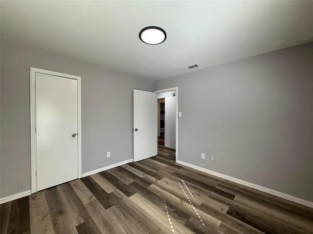 a view of a room with wooden floor and window