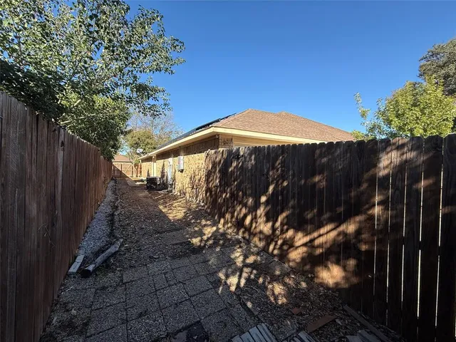 a view of a backyard with wooden fence