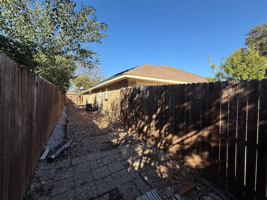 3515 Hilltop Lane Plano, TX 75023 - Photo 18 of 19 a view of a backyard with wooden fence