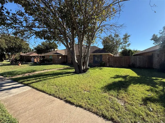 a view of a backyard with large trees