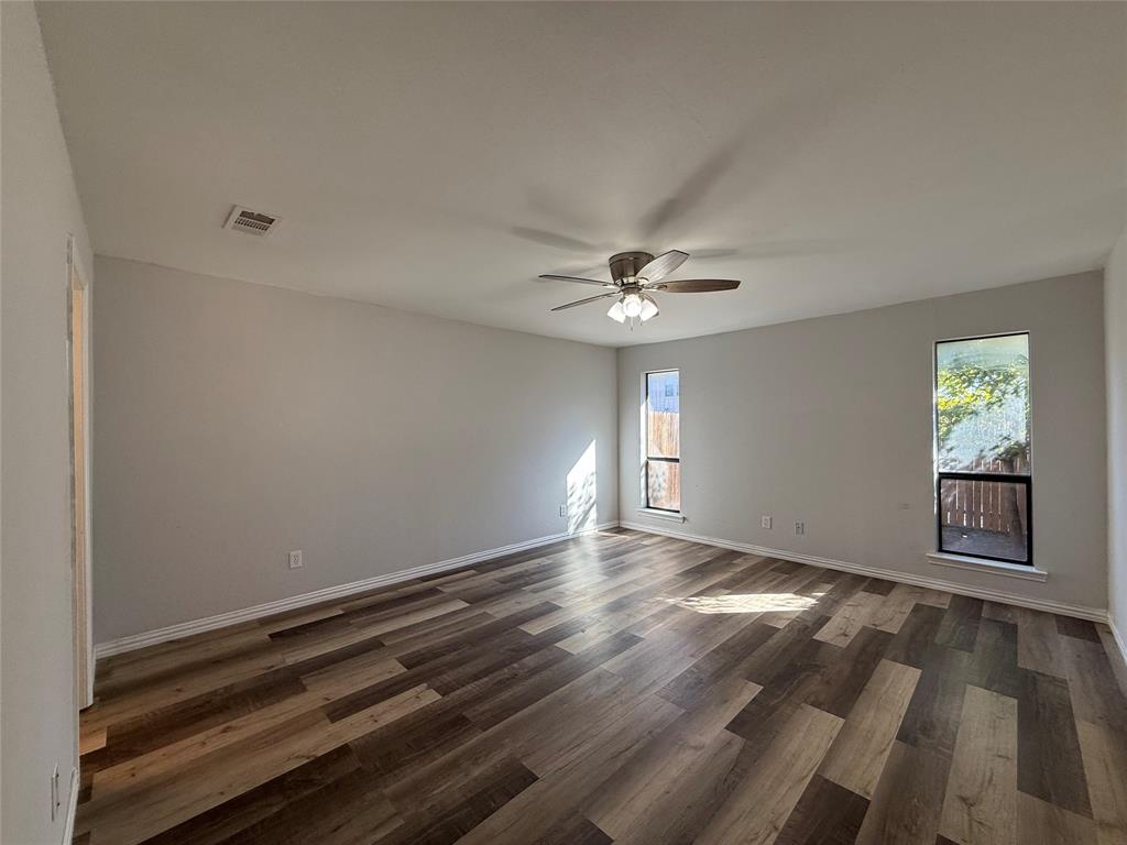 3515 Hilltop Lane Plano, TX 75023 - Photo 9 of 19 a view of an empty room with window and wooden floor