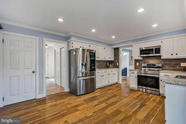 a kitchen with stainless steel appliances a refrigerator stove and microwave
