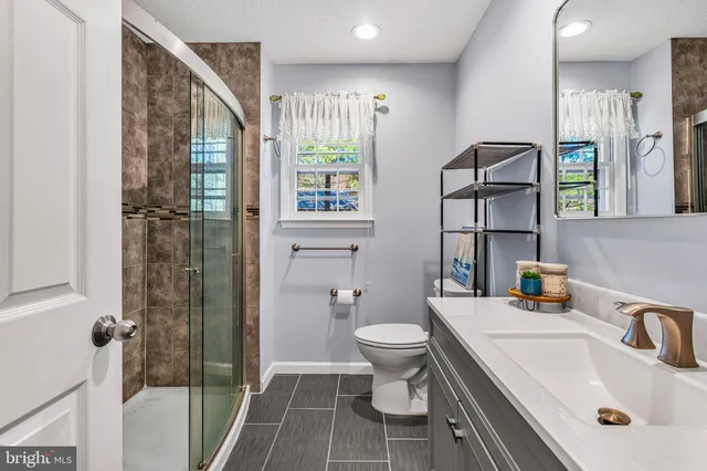 a bathroom with a sink toilet and shower