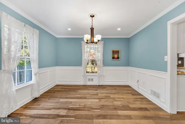 a view of empty room with window and ceiling fan