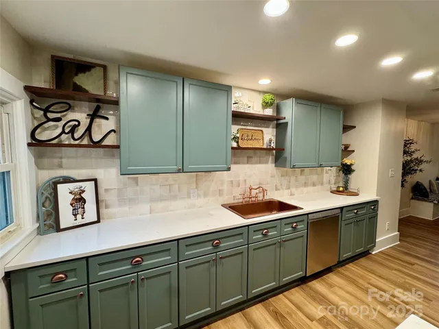 a kitchen with stainless steel appliances granite countertop a sink and cabinets