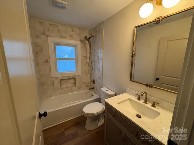 a bathroom with a sink toilet tub and shower
