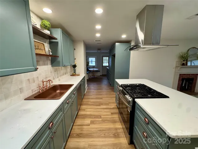 a kitchen with kitchen island a sink and stove