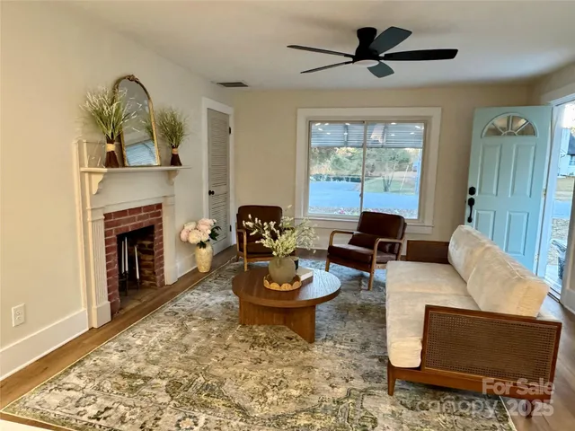 a living room with furniture and a fireplace
