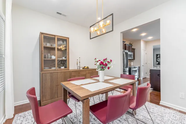 a view of a dining room with furniture and wooden floor