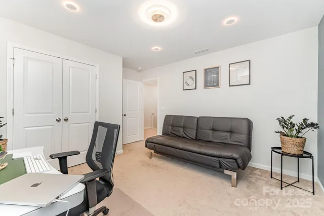 a living room with furniture and a chair