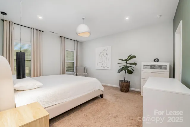 a bedroom with a bed and ceiling fan