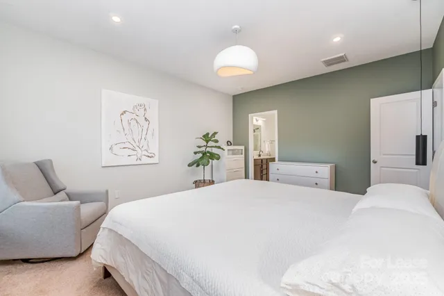 a bedroom with a bed and a couch