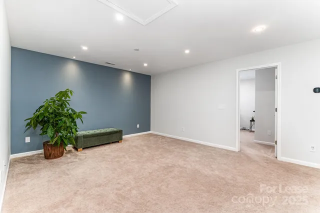 an empty room with potted plants