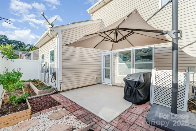 a view of a two chairs and table in the patio