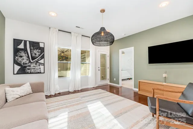 a bedroom with furniture and a flat screen tv