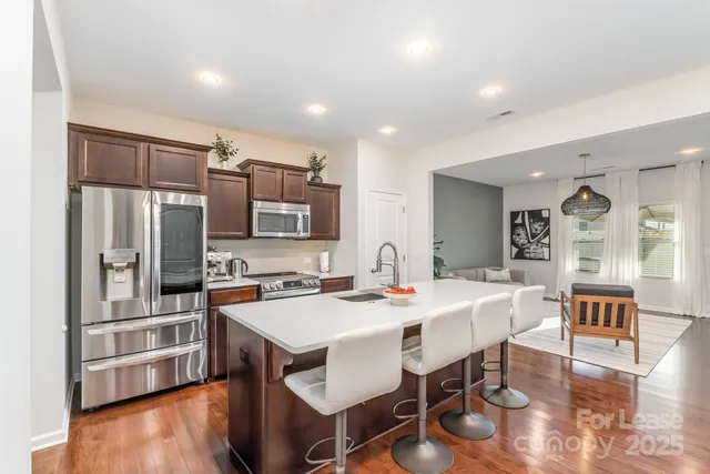 a large kitchen with a table and chairs