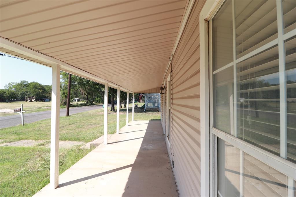 1065 West Pecan Street Stephenville, TX 76401 - Photo 2 of 40 Covered porch with a lawn