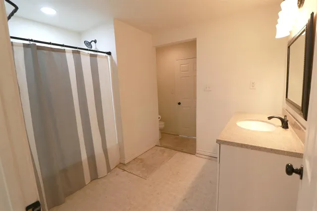 a bathroom with a sink a mirror and a shower