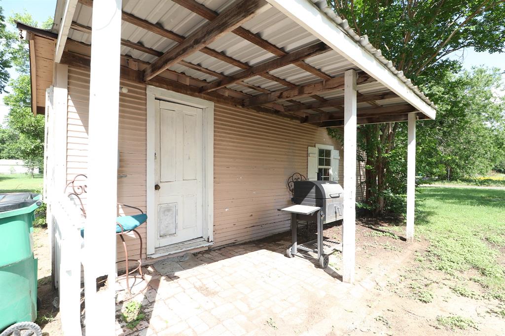 1065 West Pecan Street Stephenville, TX 76401 - Photo 7 of 40 View of back shed porch area