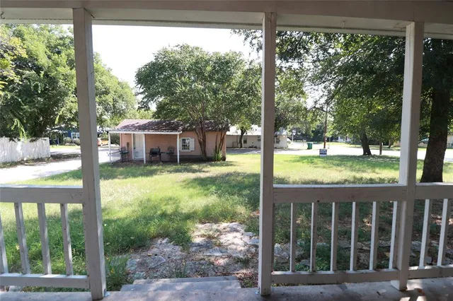 a view of a house with backyard from a porch
