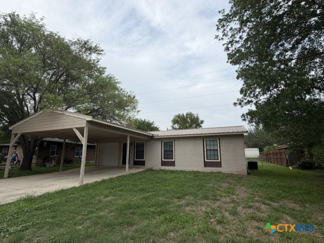 127 Hillcrest Drive Luling, TX 78648 - Photo 1 of 26 a front view of a house with a garden