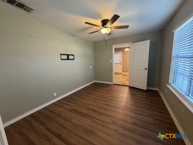127 Hillcrest Drive Luling, TX 78648 - Photo 13 of 26 wooden floor in an empty room with a window
