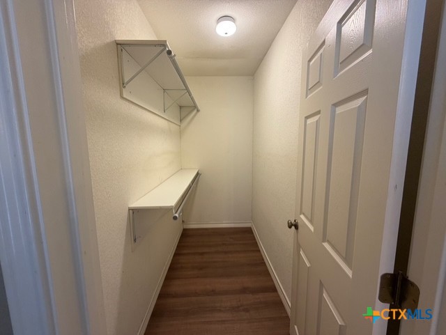 127 Hillcrest Drive Luling, TX 78648 - Photo 17 of 26 a view of a hallway with wooden floor and staircase