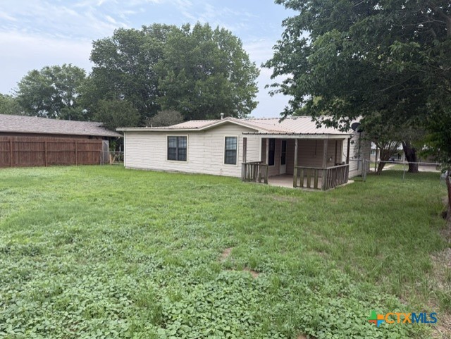127 Hillcrest Drive Luling, TX 78648 - Photo 2 of 26 a front view of a house with a garden and trees