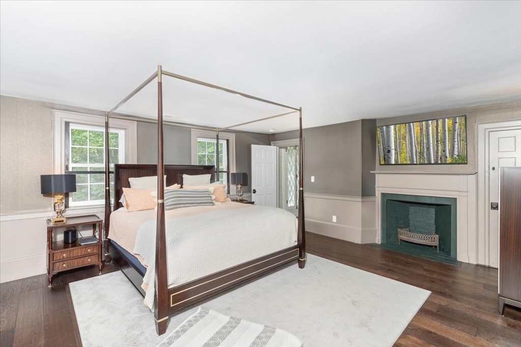 77 Main Street Boxford, MA 01921 - Photo 12 of 32 a bed room with a bed and a fireplace