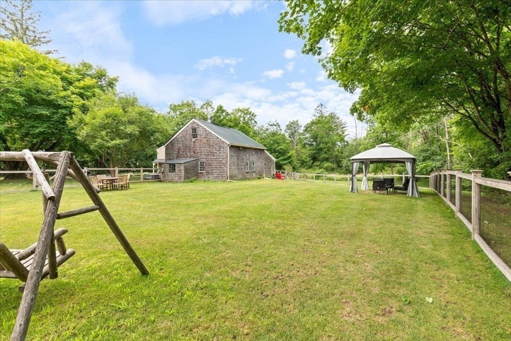 77 Main Street Boxford, MA 01921 - Photo 24 of 32 a view of a house with a backyard and a slide