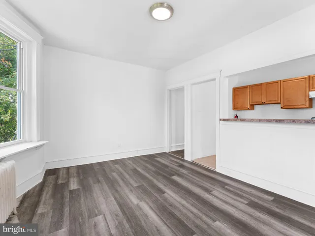 a view of a room with wooden floor and window
