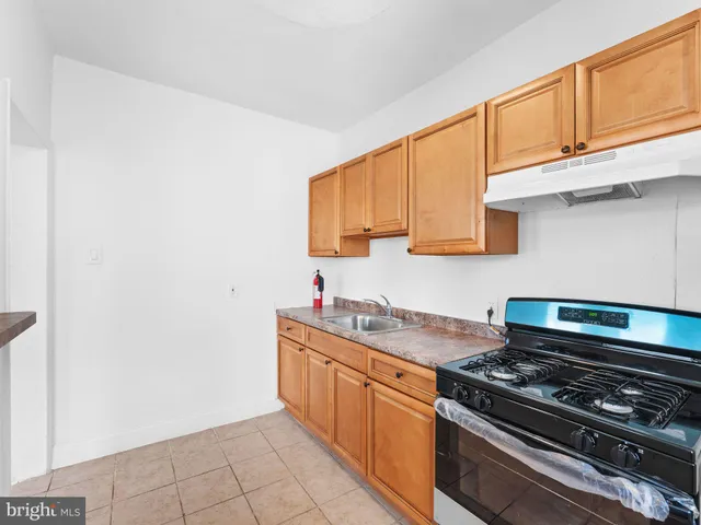 a kitchen with stainless steel appliances granite countertop a stove a sink and dishwasher