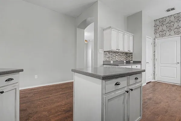 a view of cabinets counter space and wooden floor