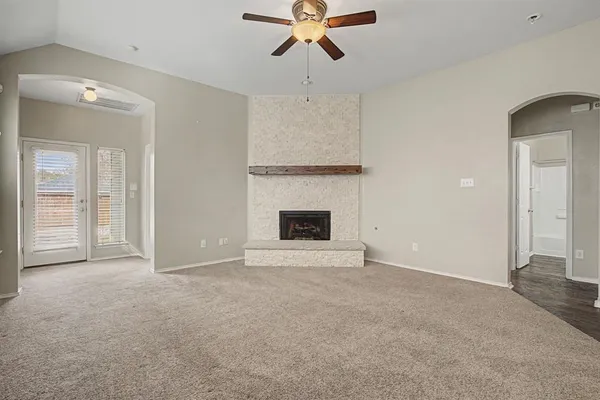a view of an empty room with a fireplace