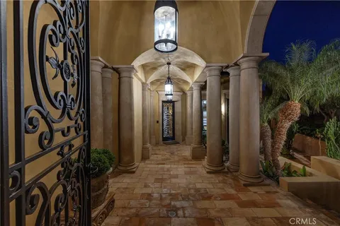 a view of staircase with lots of frames on wall and windows
