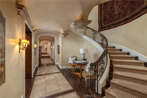 a living room with furniture large window and wooden floor