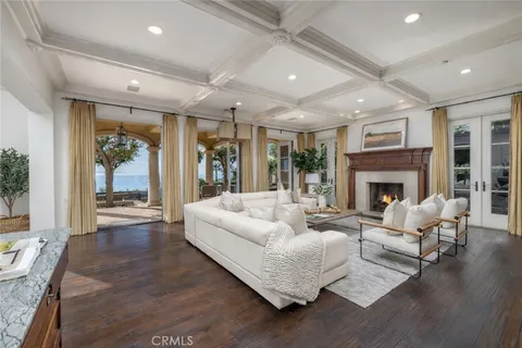 a living room with furniture potted plant and a large window