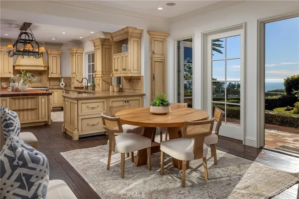 a view of a dining room with furniture wooden floor and chandelier