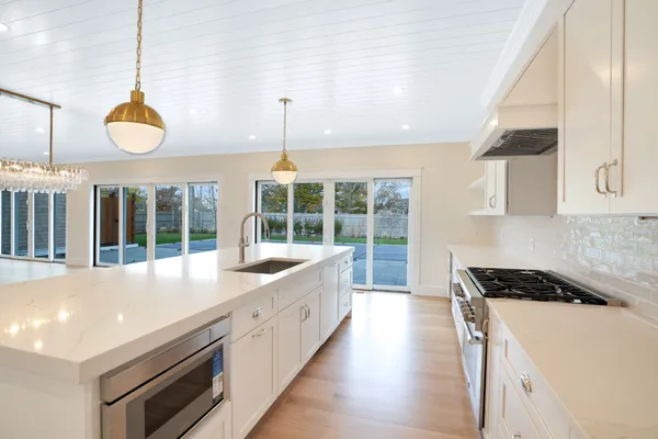 a view of kitchen and refrigerator