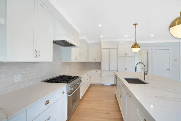 a view of a hallway with wooden floor and entryway