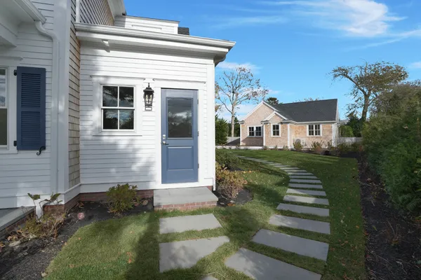 a view of pool with yard in front of it