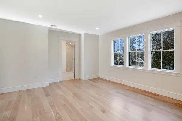 a view of a room with lots of wooden cabinets